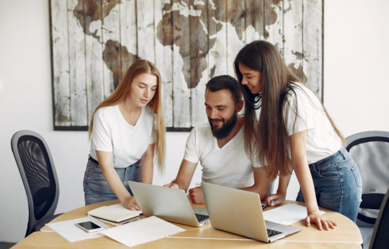 Student reviewing financial planning materials with laptop and calculator